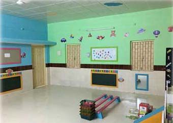 A room with a lot of toys and a chalkboard on the wall.