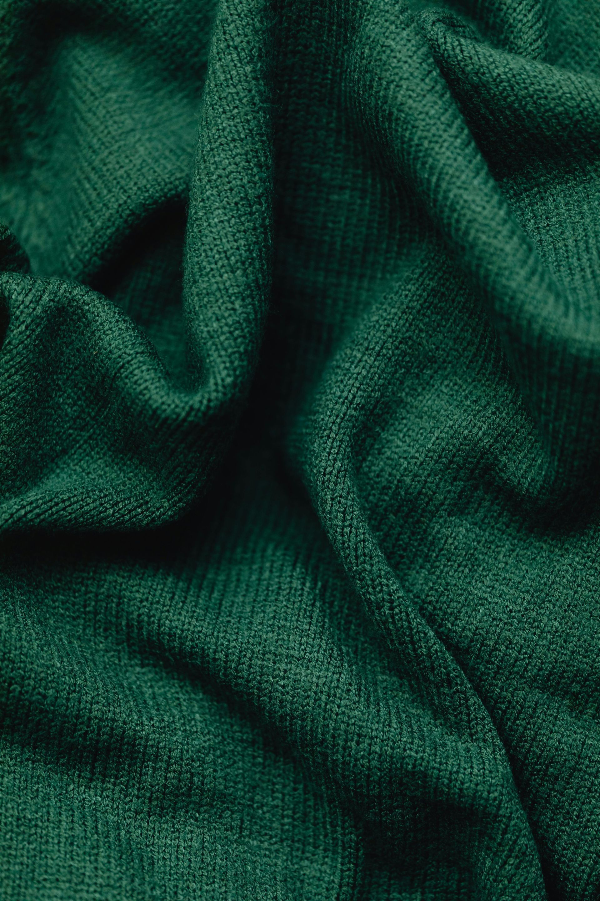 A close up of a green fabric texture.