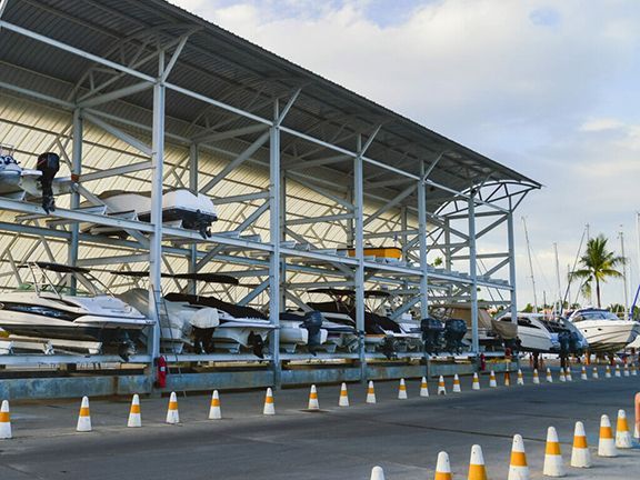 Boats of all kinds safely stored in metal buildings over wintertime.