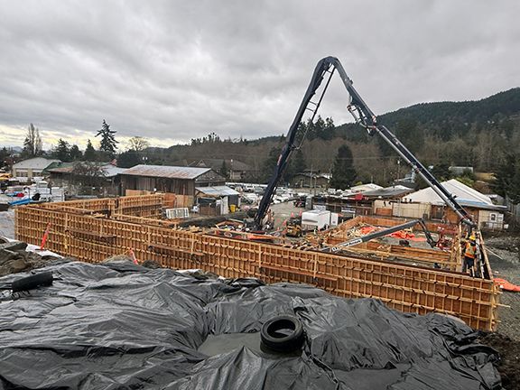 Wooden forms being installed prior to concrete being poured at construction site on Salt Spring Island.