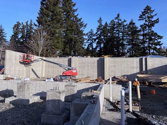 Concrete retaining wall being added by Double Black Construction.
