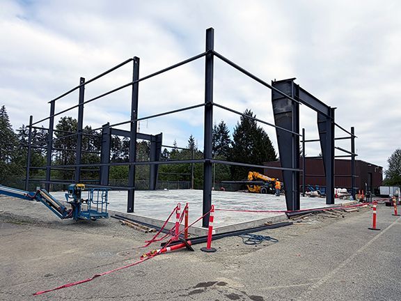 Concrete foundation and steel I-beams work together for building strength