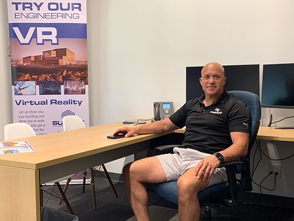 Frank Melo sits in new London office.