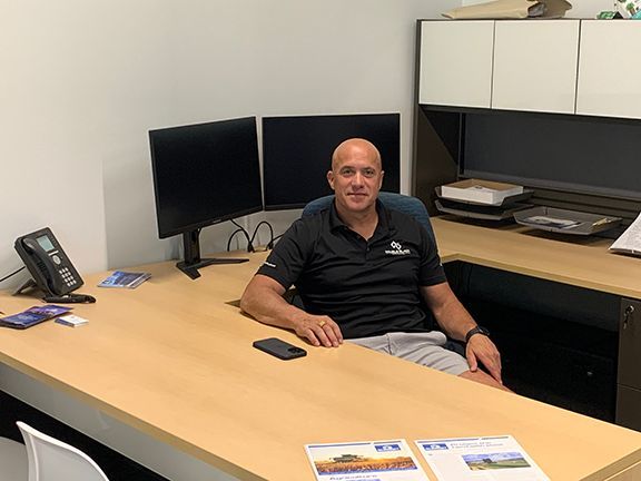 Frank Melo behind his desk in Thorndale, Ontario office.