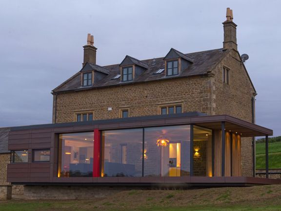 Glass and steel building extension added to older brick building.
