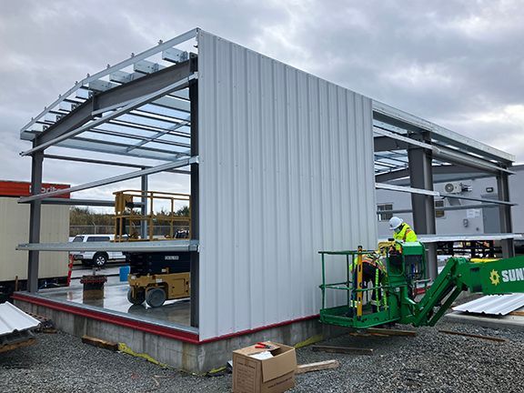 Metal panels being installed at Vancouver airport building project.