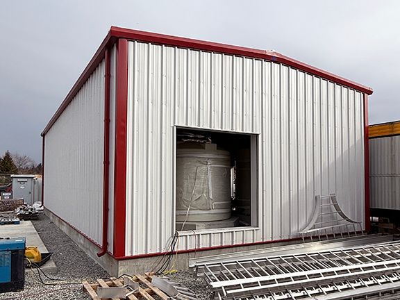 Photo of aviation fuel pump house building installed by Summit Steel Buildings showing storage containers inside.