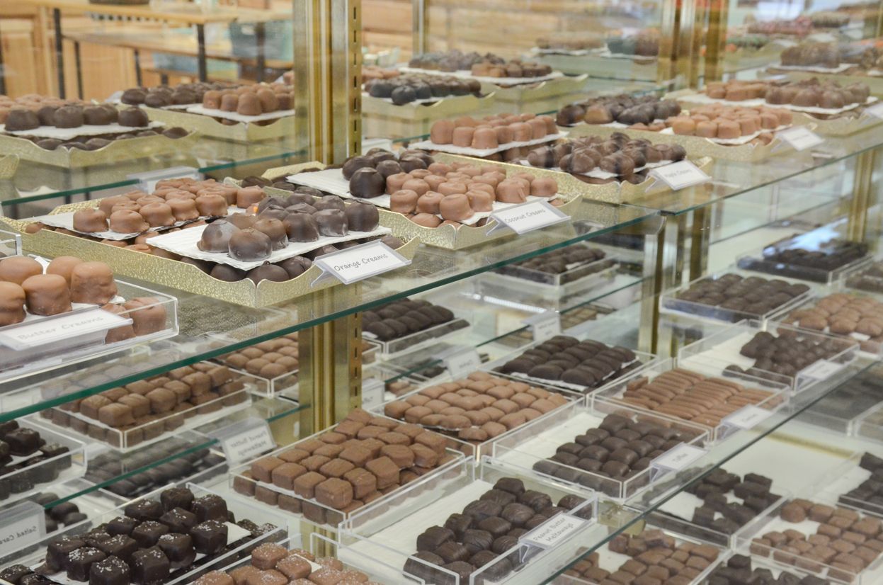 Display case filled with various chocolates in a shop.