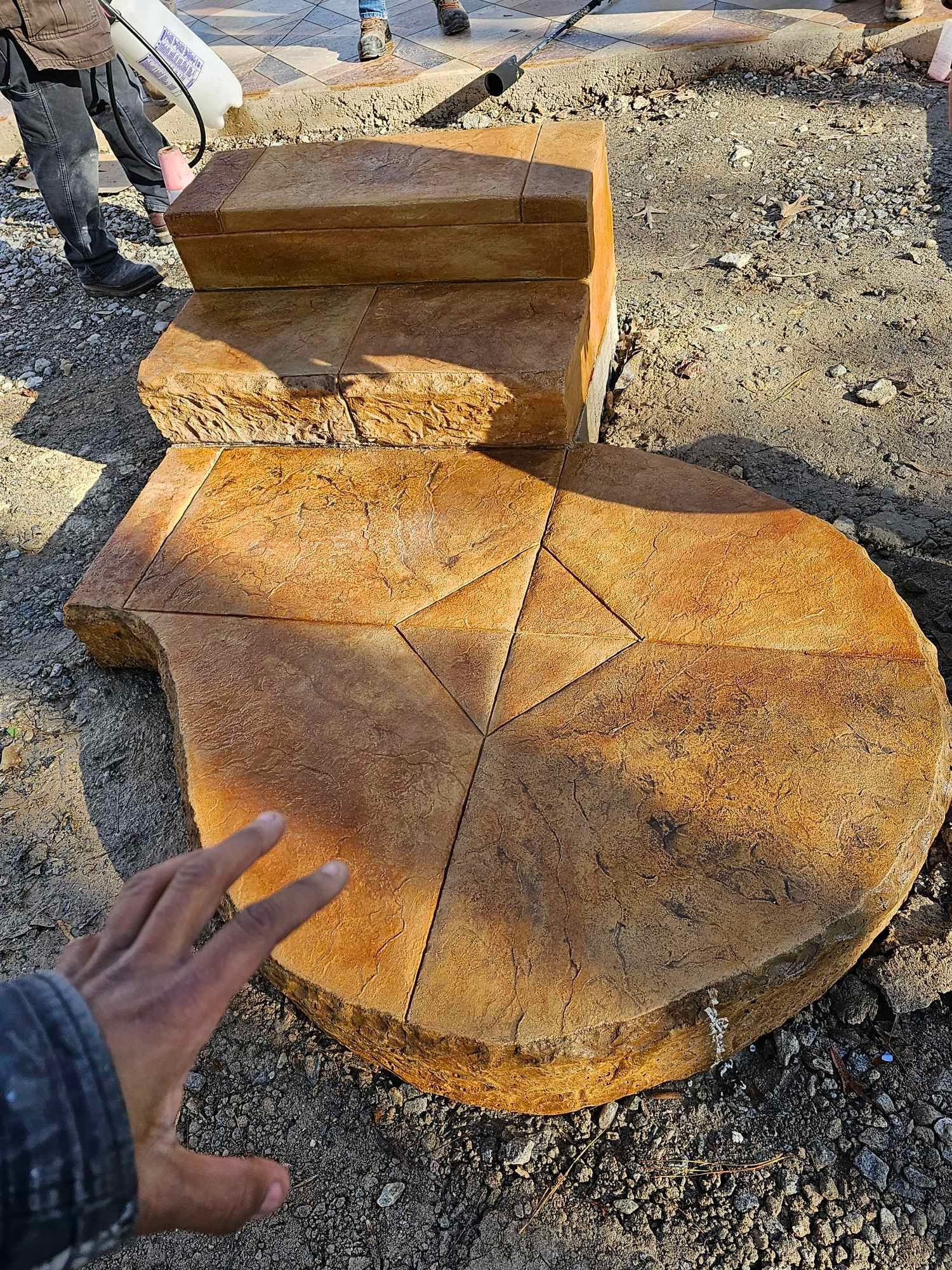a person is touching a large piece of wood on the ground .
