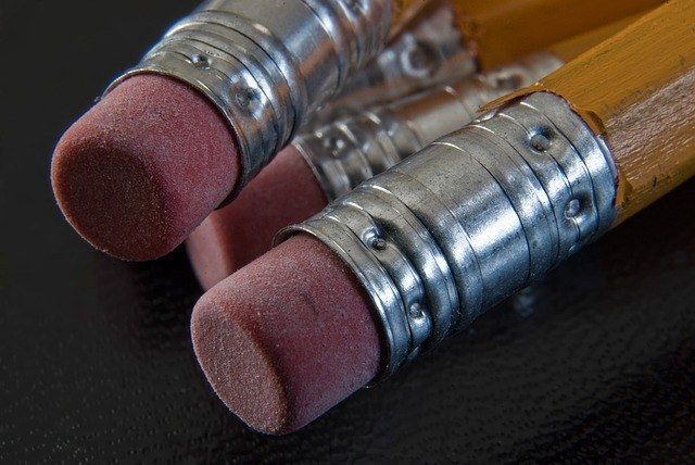 A close up of two pencils with erasers on them