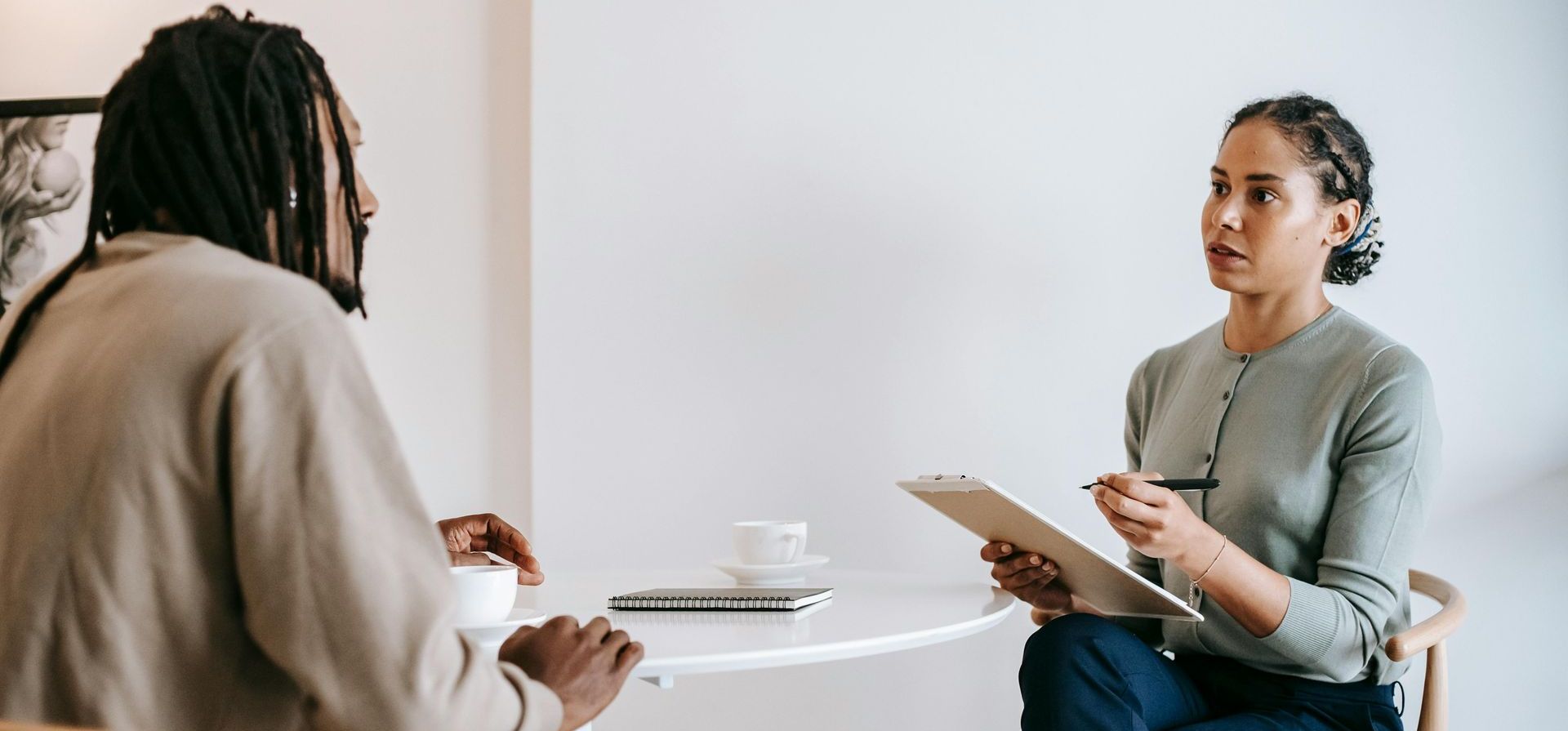 A man and a woman are sitting at a table having a conversation.