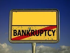 A yellow sign with the word bankruptcy on it.