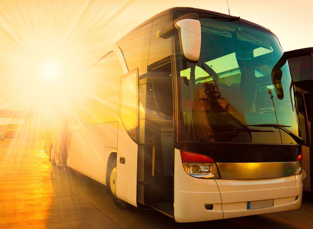 Sun Shining Over a Bus With Open Doors — Windscreen Specialist in Dubbo, NSW