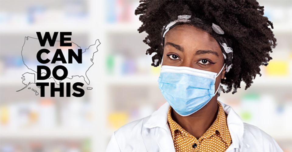 A female pharmacist wearing a face mask in a pharmacy.