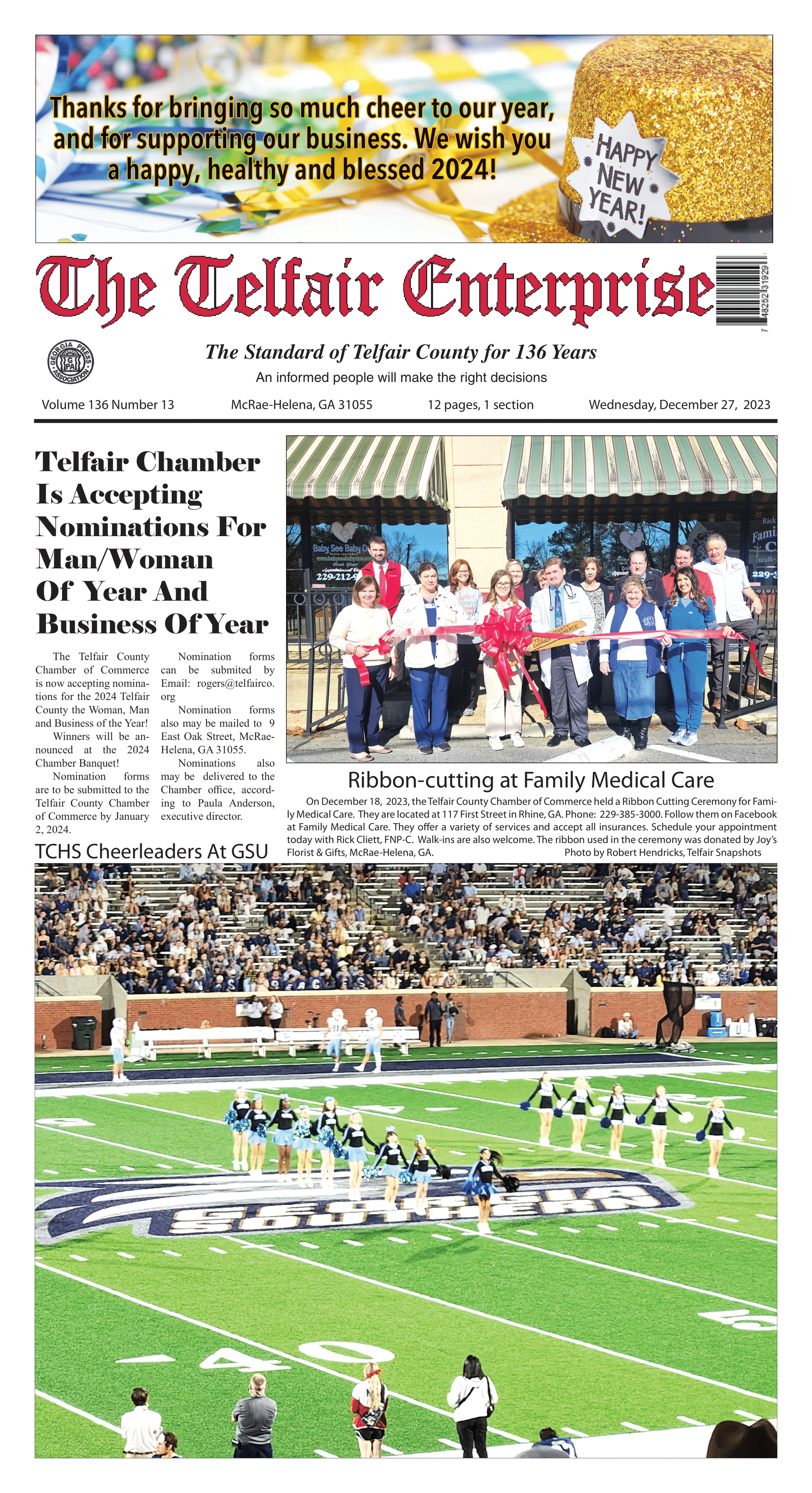 A newspaper with a picture of a football field on the front page.