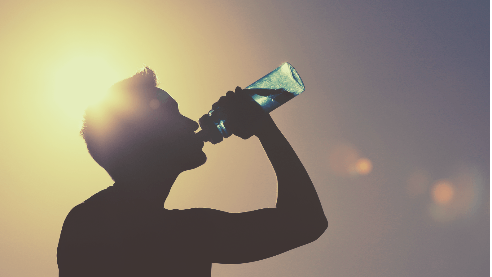 man drinking water bottle