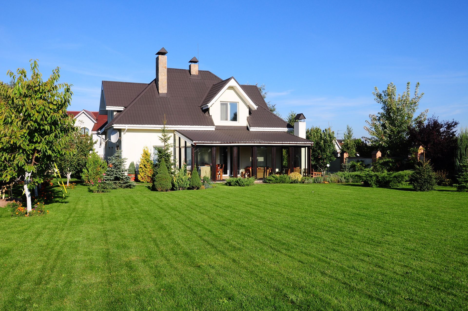 A large house with a large lawn in front of it.