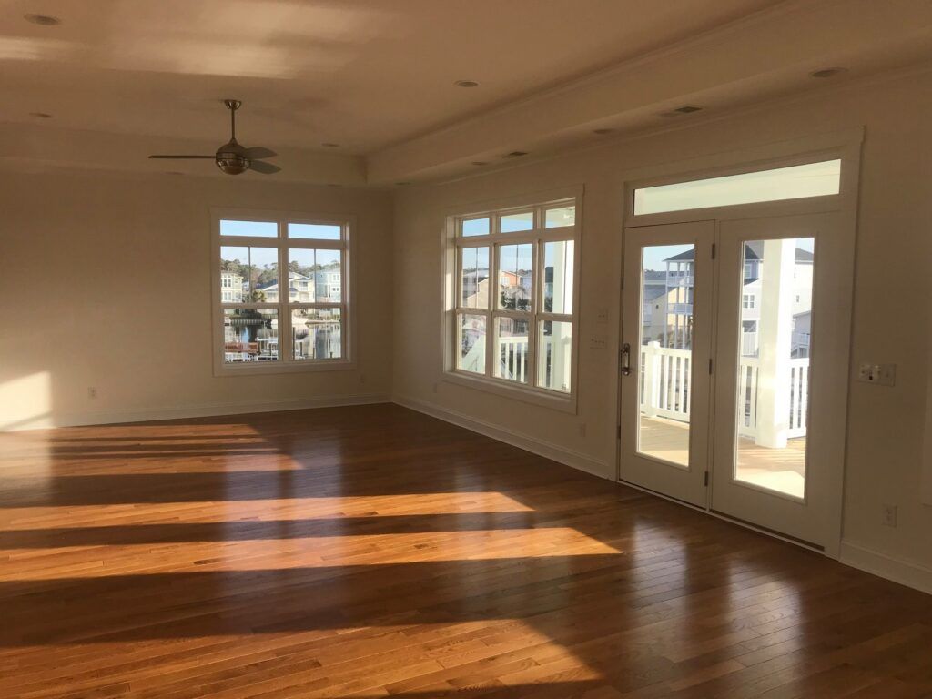 An Empty Living Room with Hardwood Floors — Brunswick County, NC — Coastal Carolina Construction