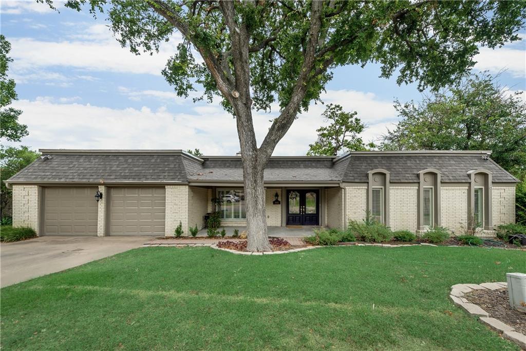 A house with a large tree in front of it