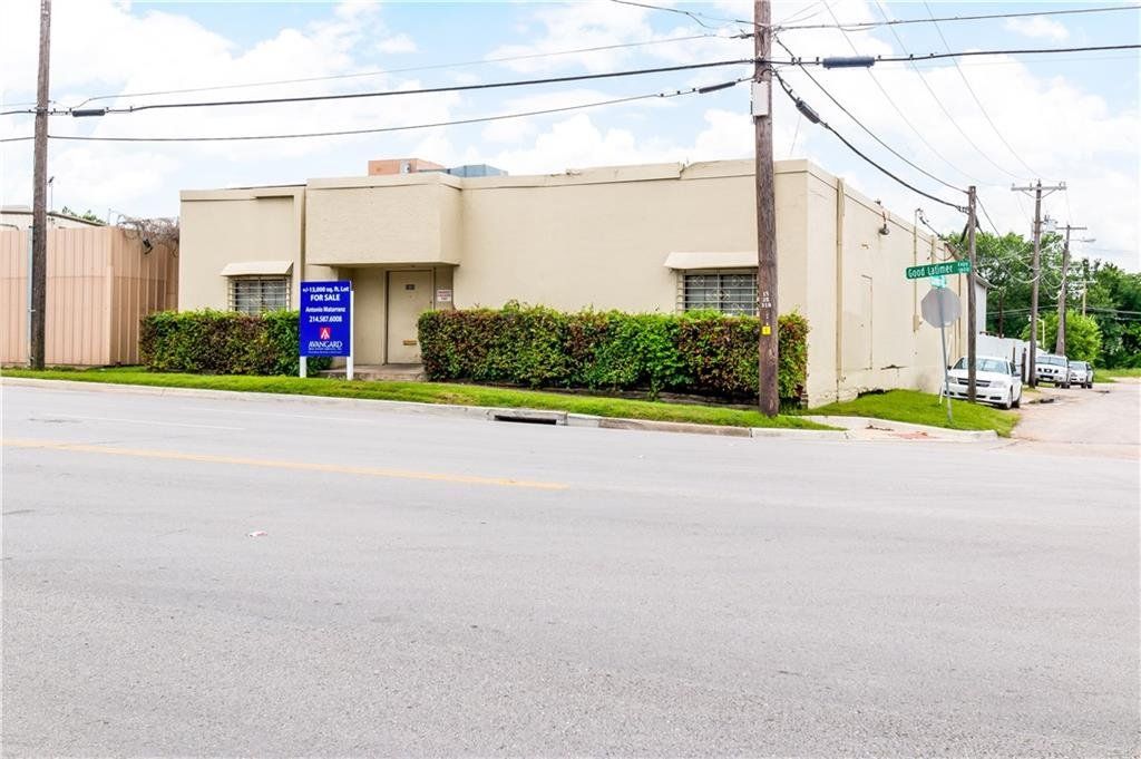 A white building with a blue sign on the side of it
