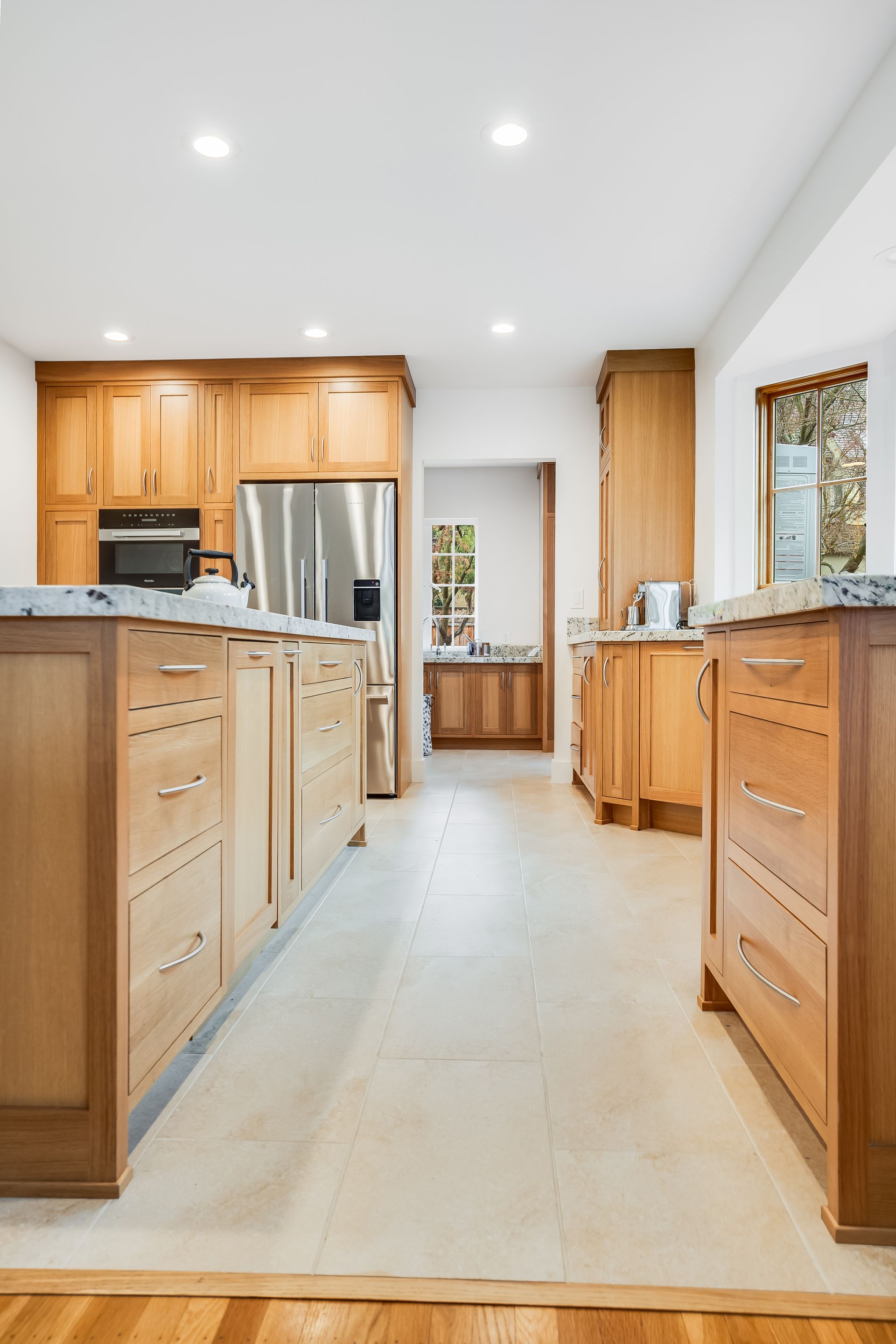 A kitchen with wooden cabinets and stainless steel appliances