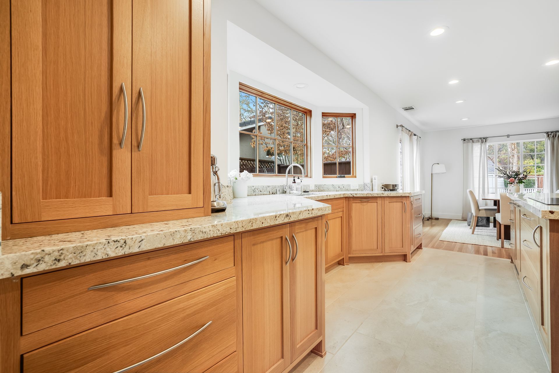 A kitchen with wooden cabinets and granite counter tops.
