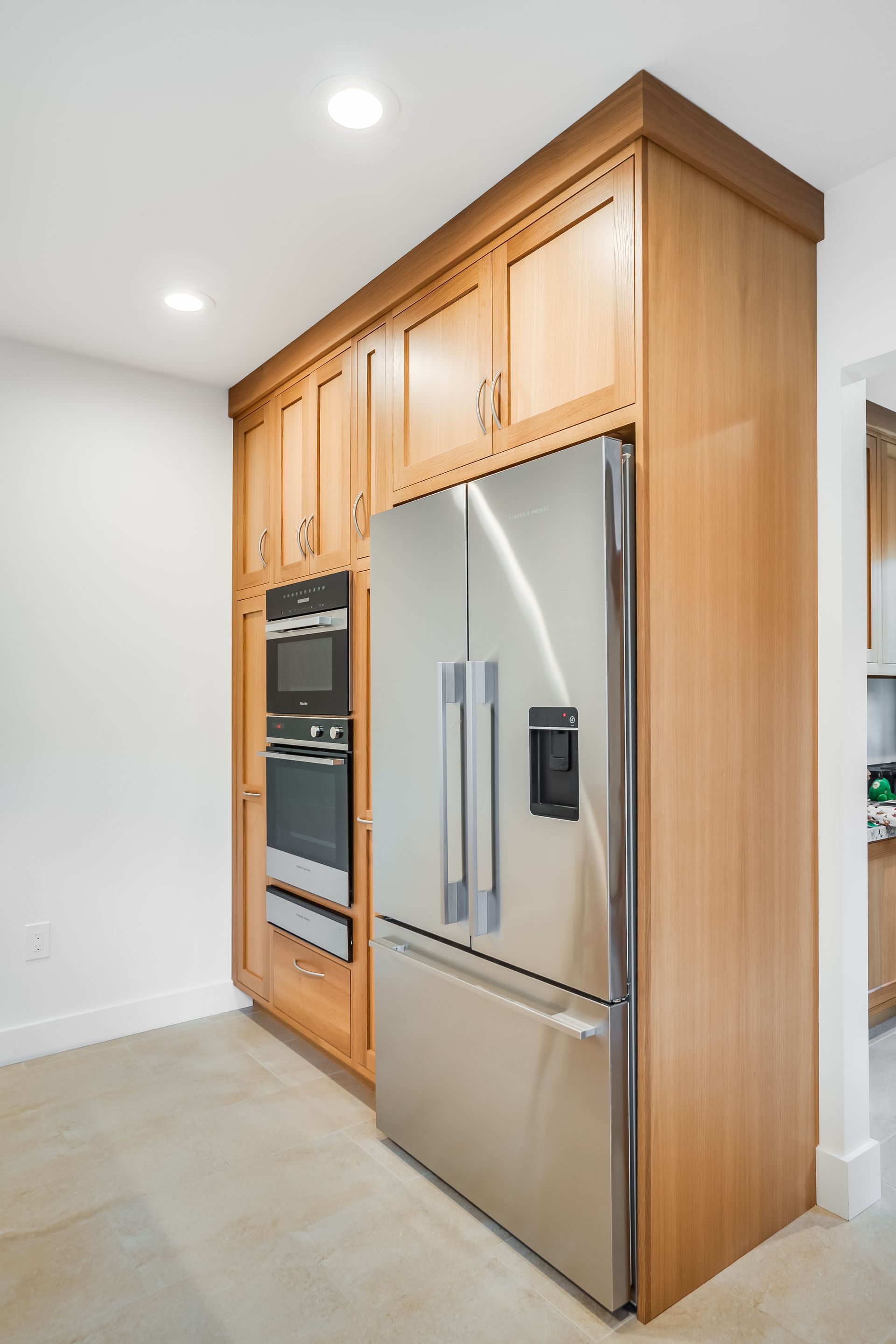 A kitchen with stainless steel appliances and wooden cabinets.