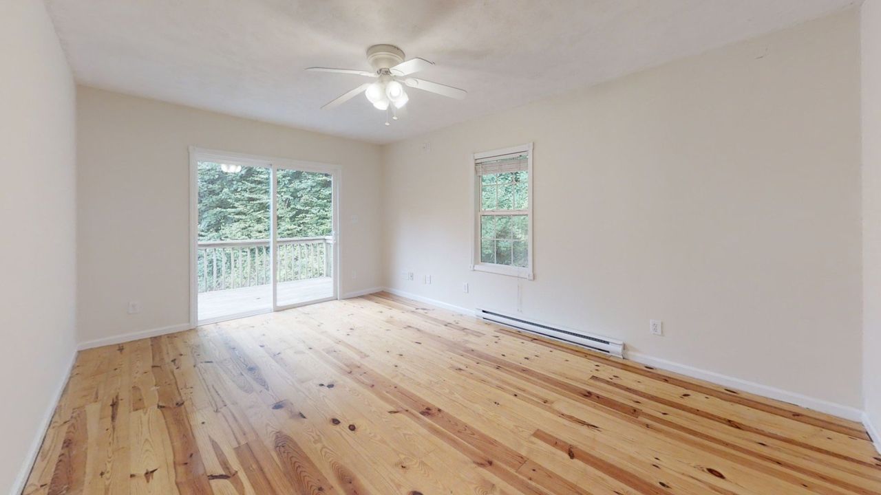 Junaluska Cabin - Bedroom with hardwood floors