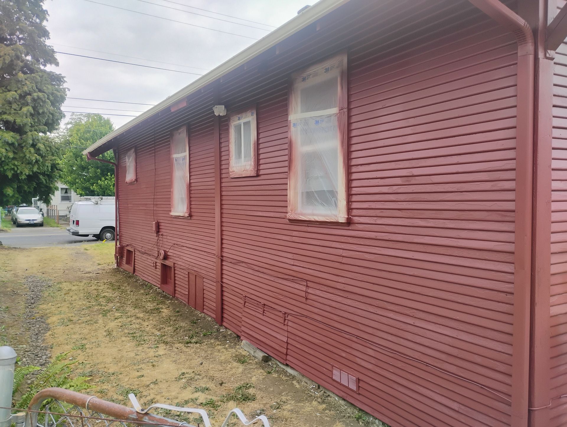 Bedroom with a bed, closet, framed art, string lights, and a window with a sheer curtain. Blue and gray tones.