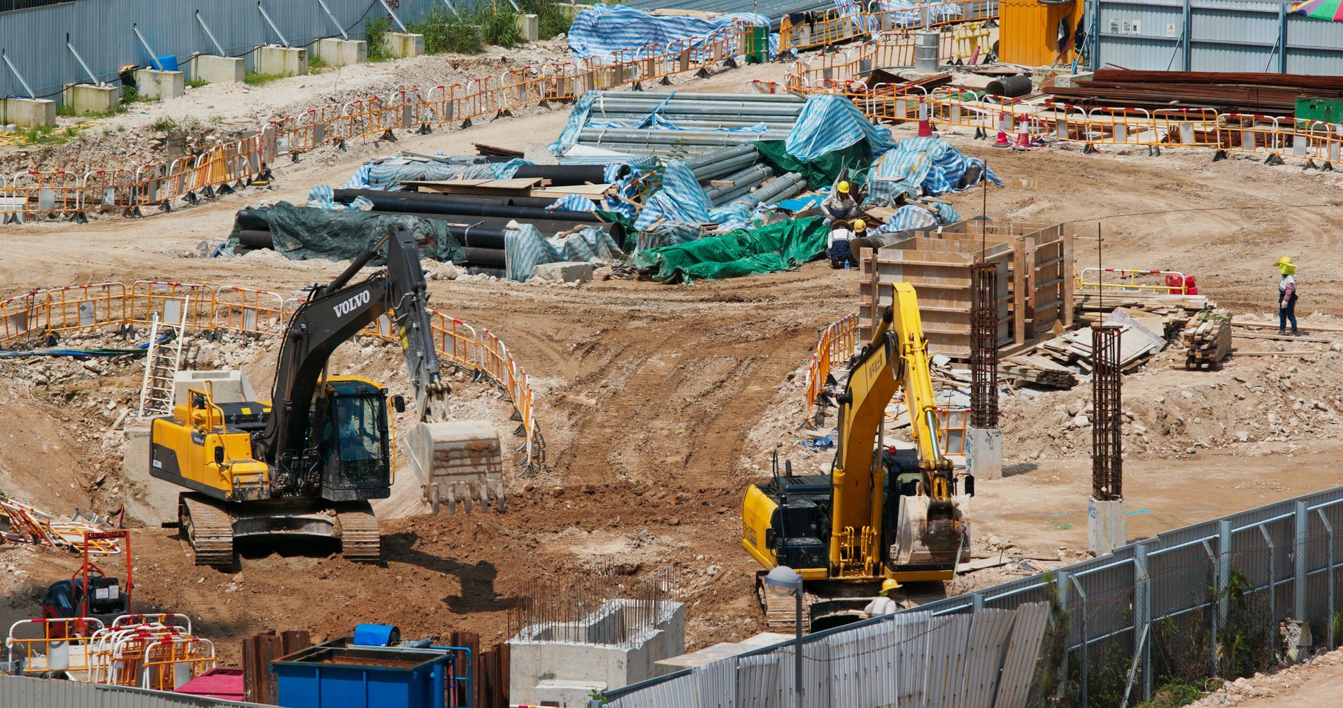 A construction site with a lot of machinery and workers.