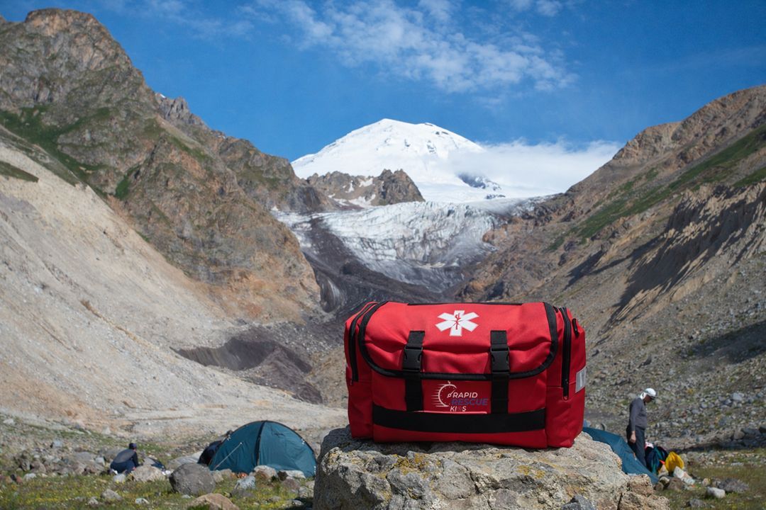 Rapid Rescue Kits emergency trauma bag staged at outdoor adventure basecamp for remote emergency