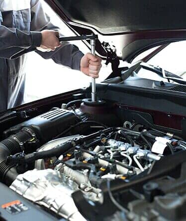 Man Repairing a Car — Engine Parts Merrillville, IN