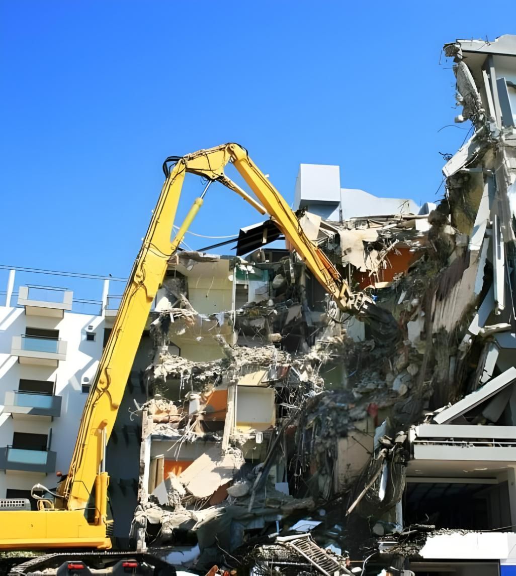 A Large Yellow Crane is Demolishing a Building — Husky Demolition In Heatherbrae, NSW