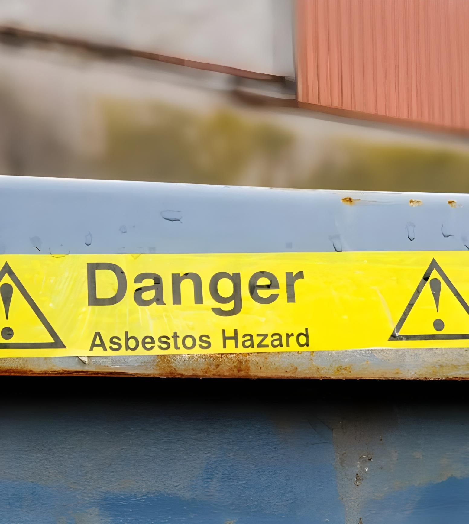 A Yellow Sign That Says Danger Asbestos Hazard — Husky Demolition In Heatherbrae, NSW