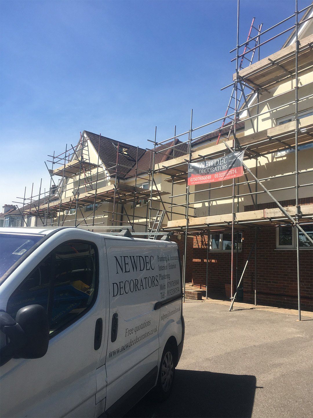 company van in front of building during renovation