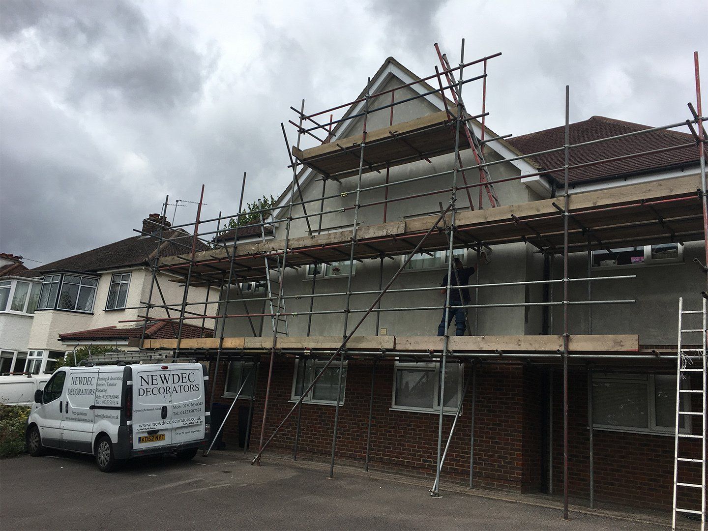 company van in front of building during renovation