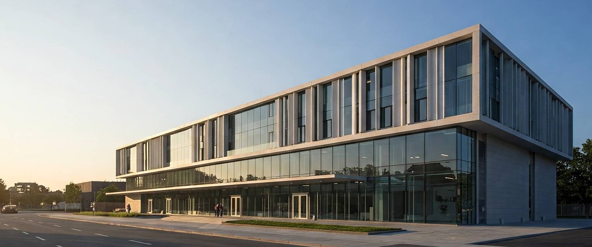 A large building with a lot of windows and a blue sky in the background.