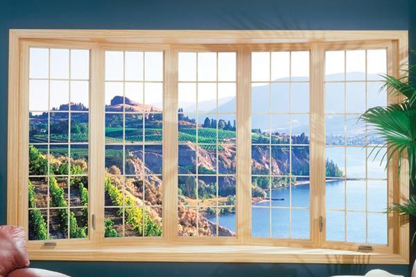 A large window with a view of a lake and mountains