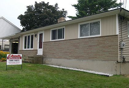 A house with a for sale sign in front of it