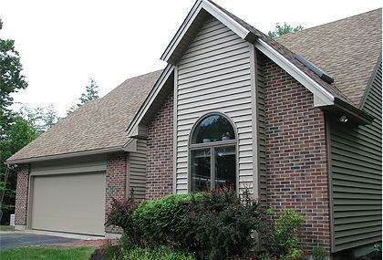 A brick house with a garage and a window