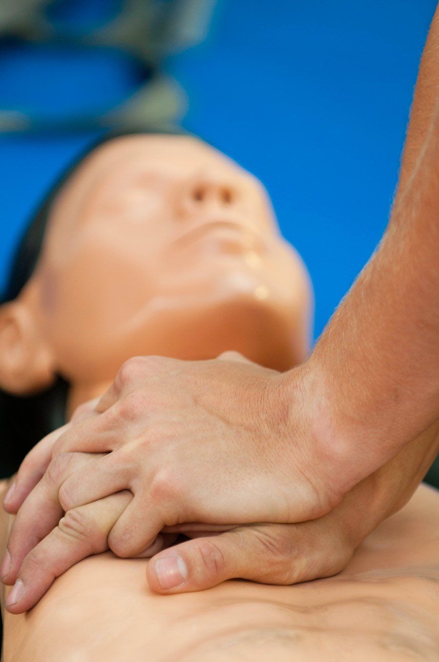 Man Performing CPR On A Dummy — Irvine,CA — University Training Center Inc