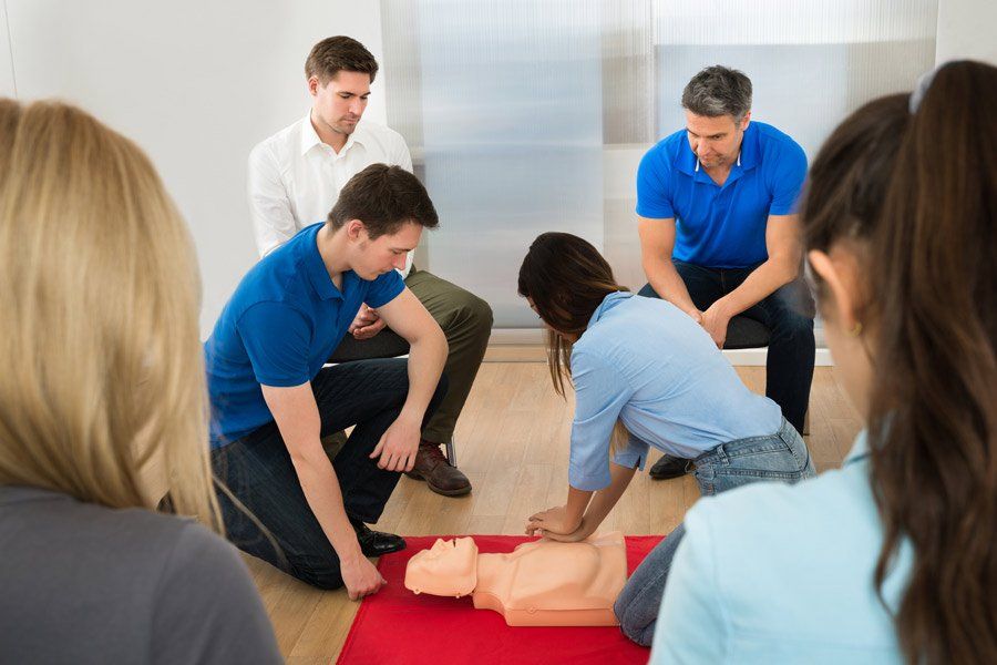 A CPR Dummy Being Used In A First Aid Training Class — Irvine,CA — University Training Center Inc