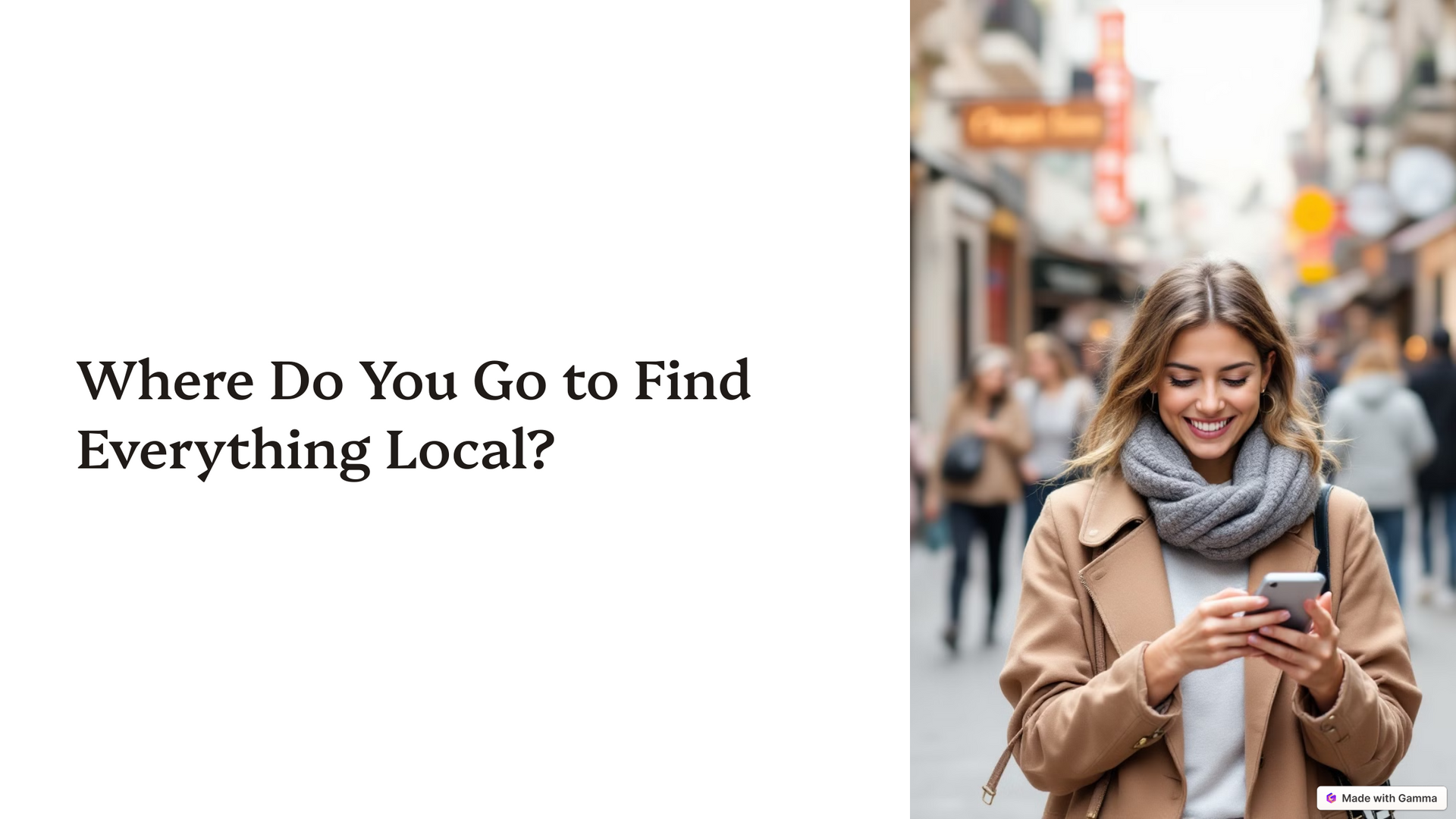 A woman is standing on a city street looking at her phone.