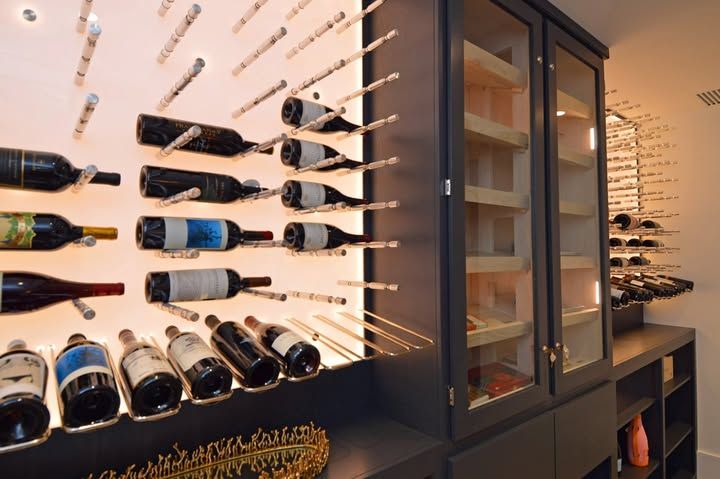 Wall-mounted wine rack with assorted bottles in a modern wine cellar