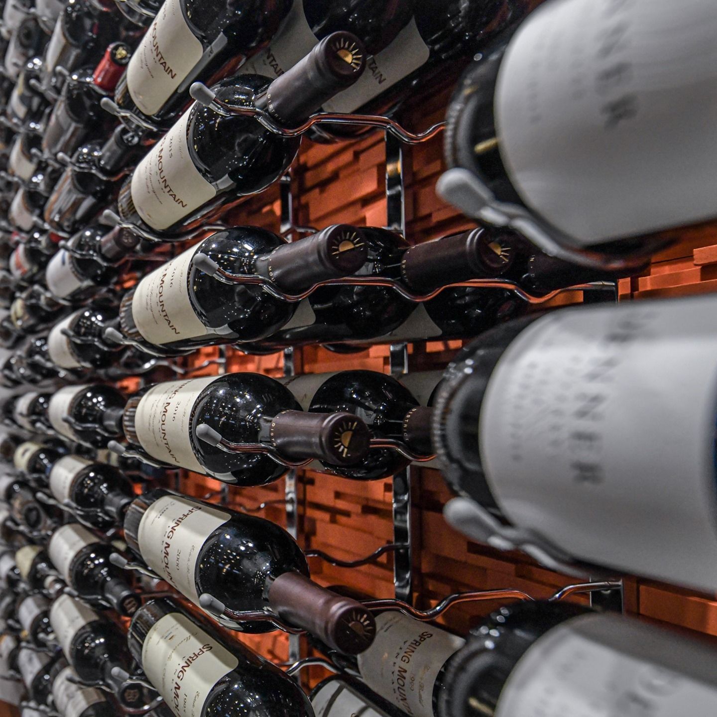 Rows of wine bottles stored horizontally in a wine cellar rack