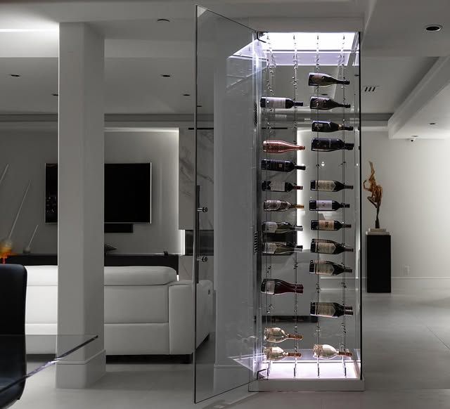 Modern living room with a glass wine cabinet and white minimalist furniture