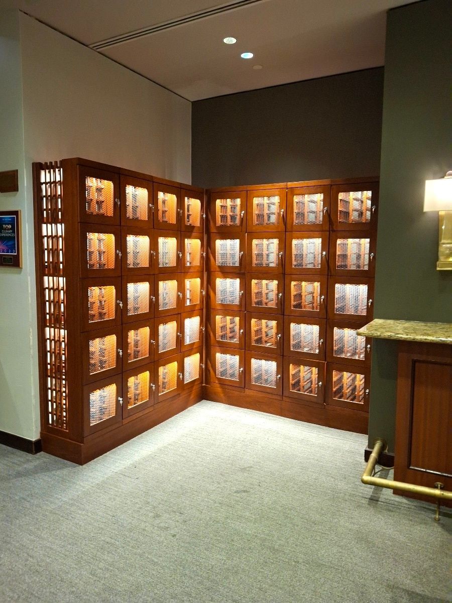 Wooden wall of memorial plaques in a carpeted indoor lobby corner