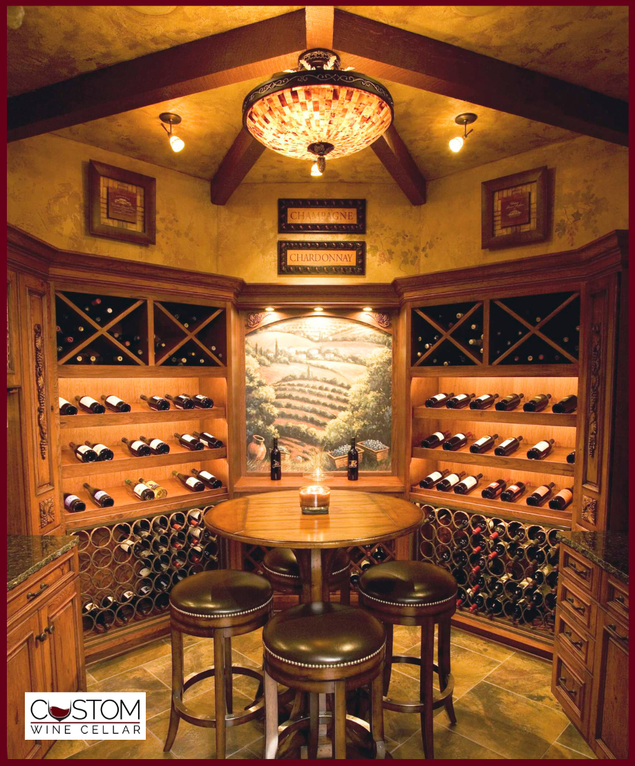 Warm wine cellar with wooden racks, round tasting table, stools, and hanging chandelier.