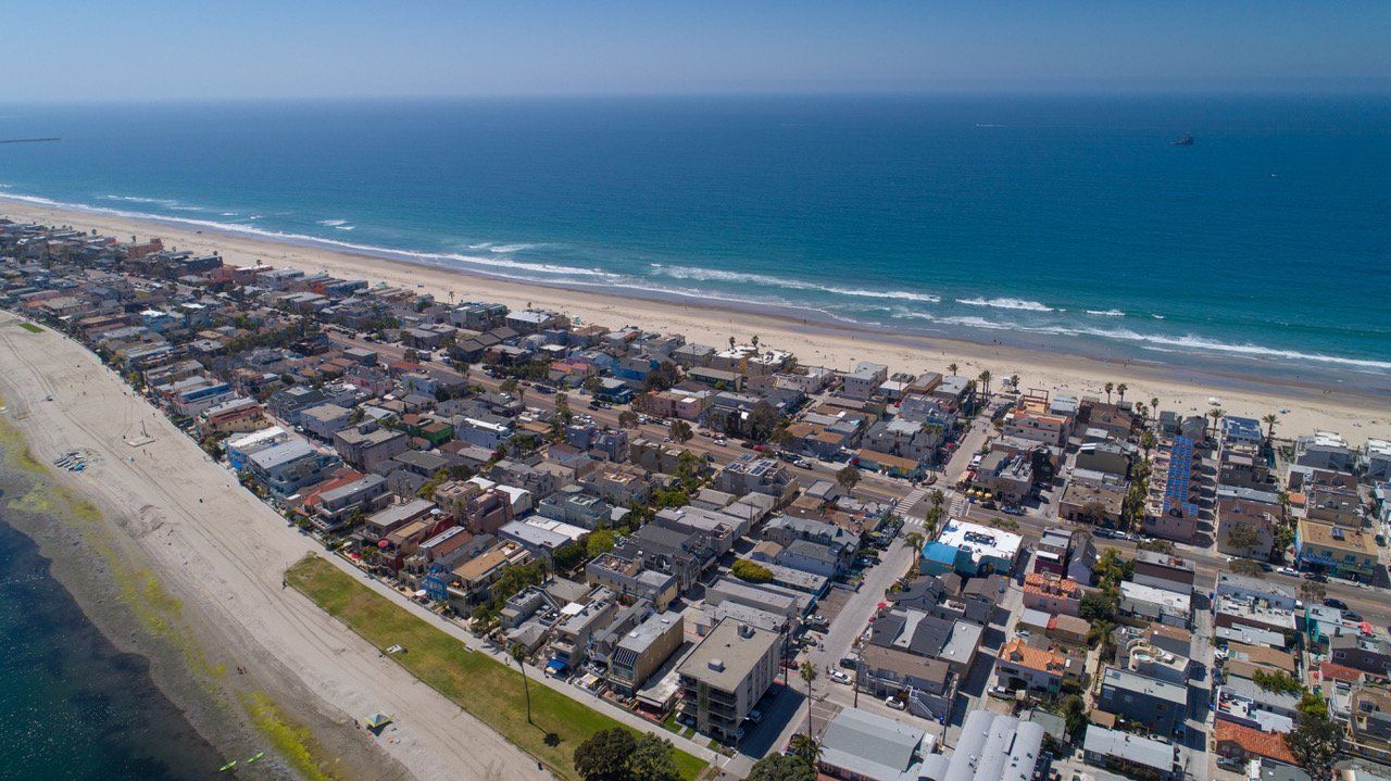 an aerial view of a city next to a beach .