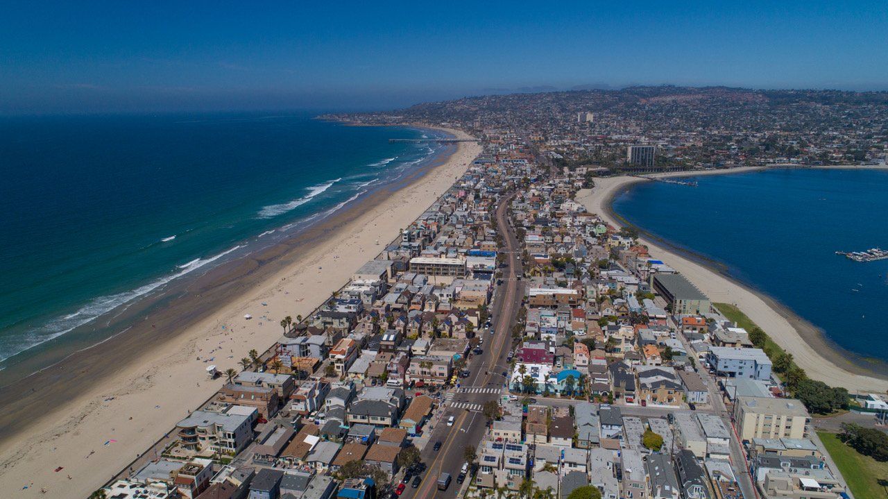 an aerial view of a city next to a beach .